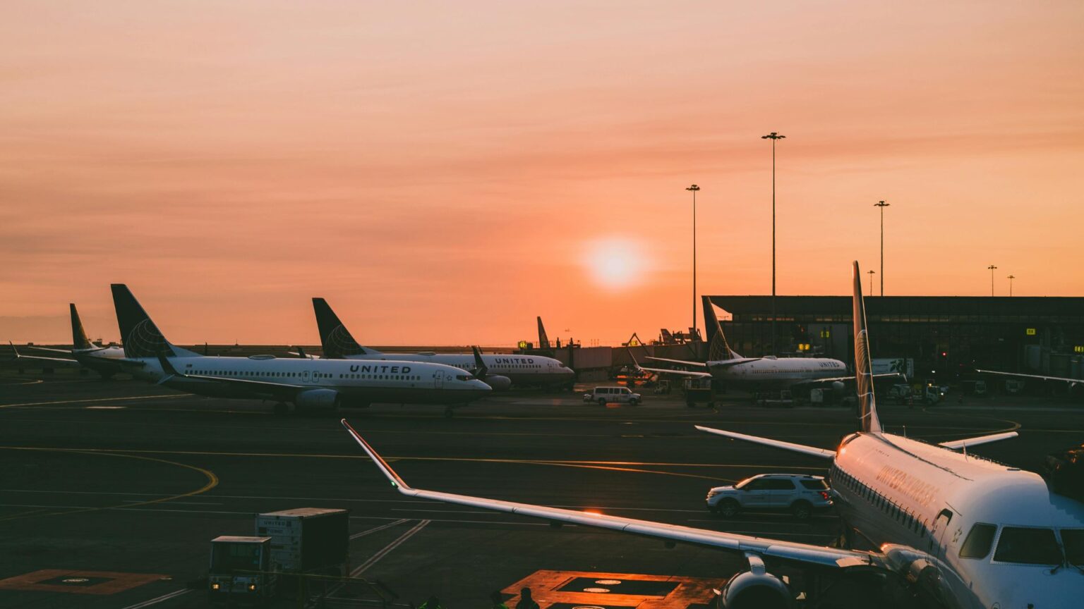 Airplanes parked at the airport at sunset