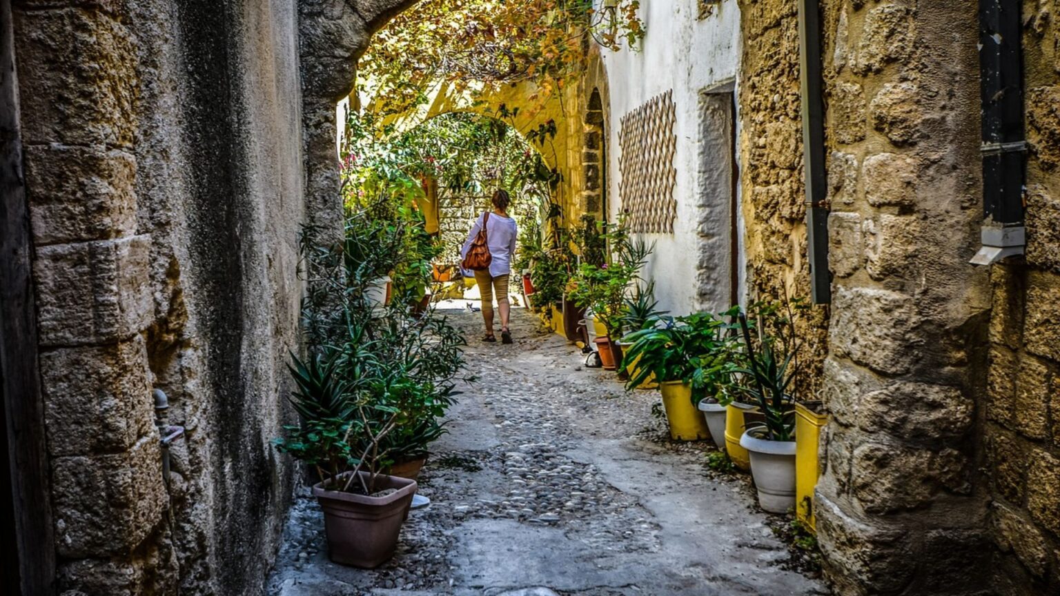 Woman wlaking cobblestone streets