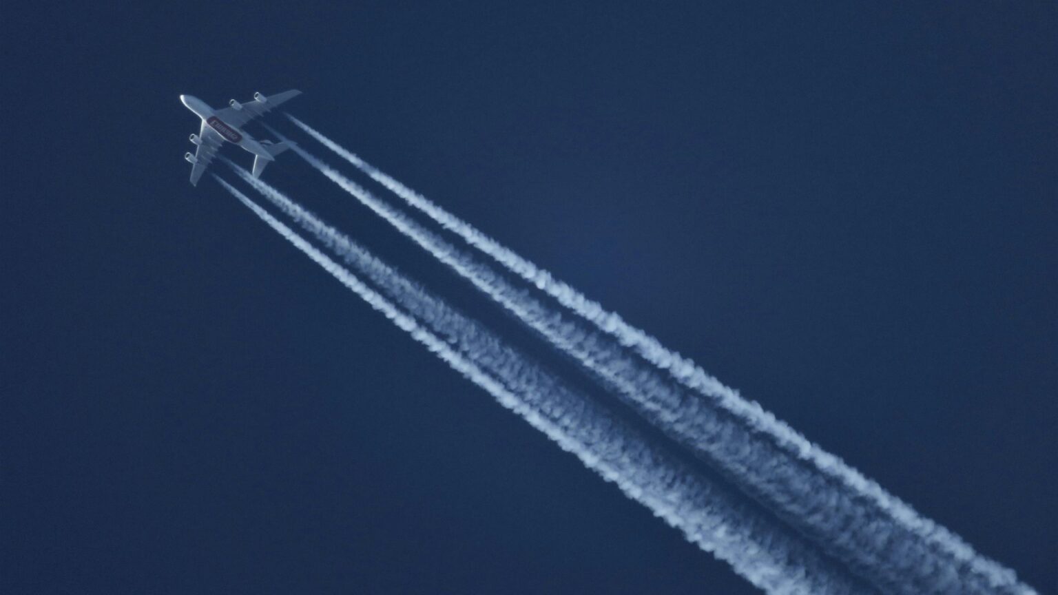 Airplane with jet streams in the sky